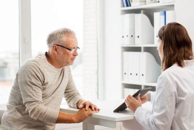 an elderly man consulting a doctor