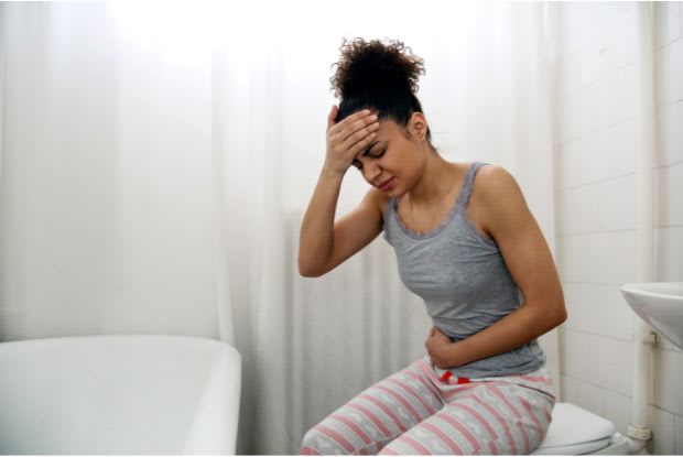 a woman sitting on a toilet