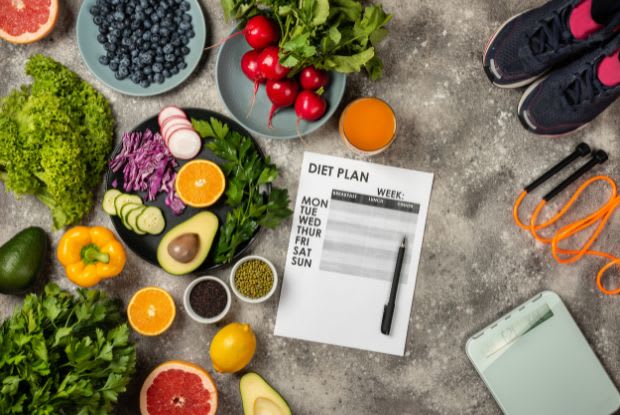 a diet plan surrounded by healthy food