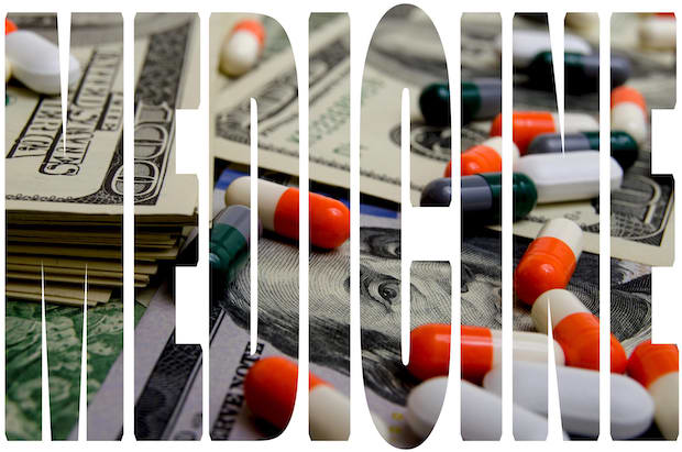 The word “Medicine” on a background of dollars and pills.
