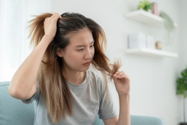 woman checking for thinning hair