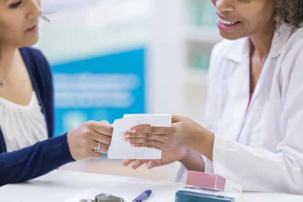 pharmacist explaining medication to a patient