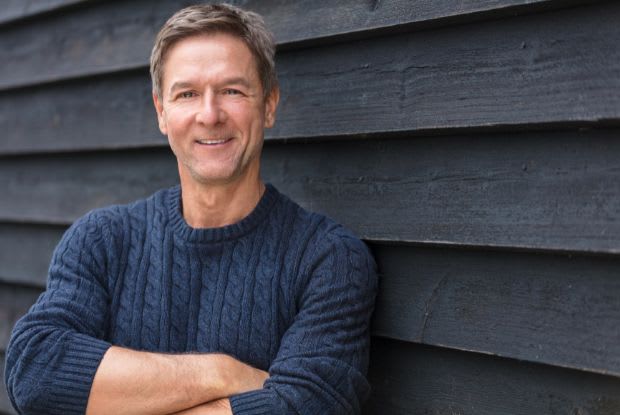 happy man with his arms crossed