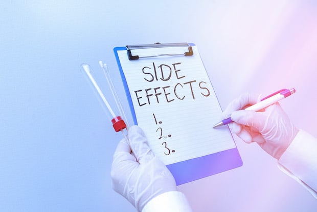 A graphic of gloved hands holding a side effect chart. 