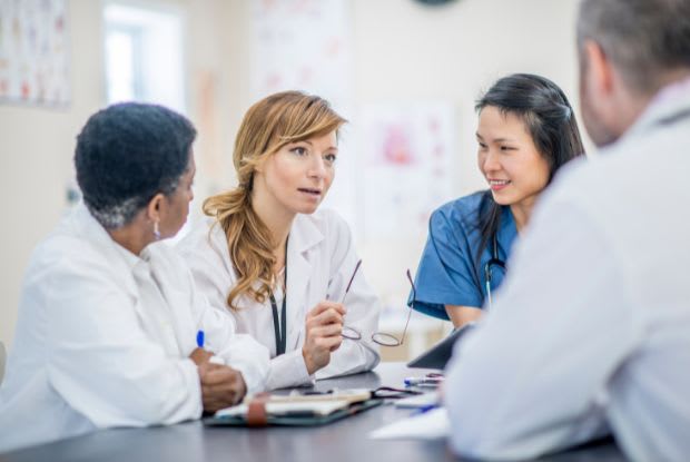 a group of researchers having a conversation