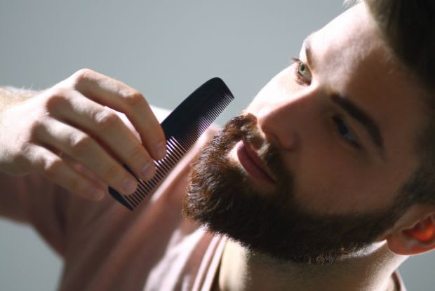 a man combing his beard