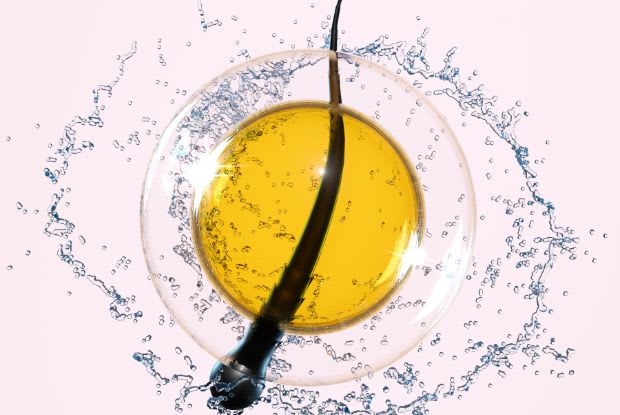 a strand of hair surrounded by serum