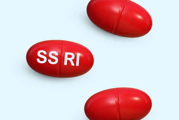 Red tablets labelled with SSRI on a blue background