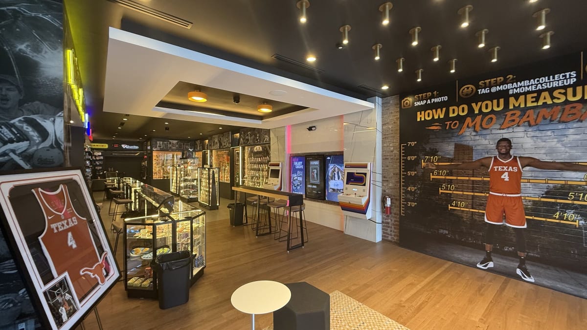 The sales floor at Mo Bamba Cards & Collectibles with the How Do You Measure Up wall
