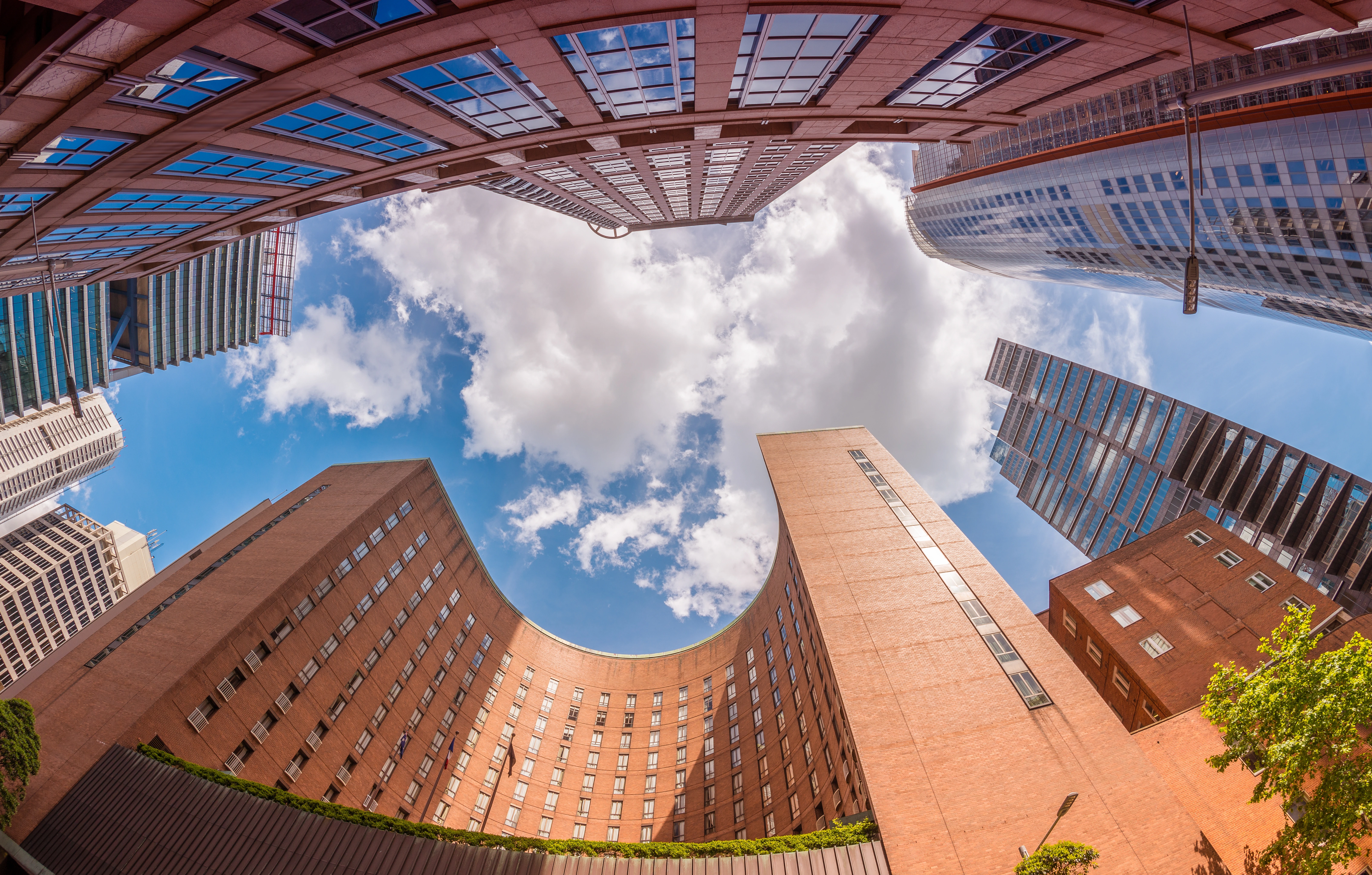 Skyscrapers viewed from below against a bright sky