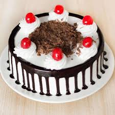 Black forest cake topped with cherries ana=d chocolate slices