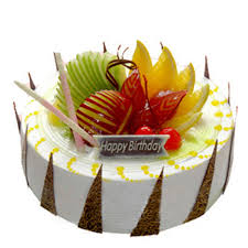 Round shaped fruit cake garnished with fruits