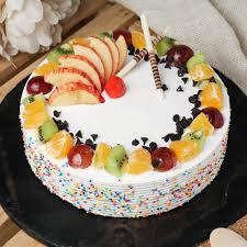 Fruit cake garnished with sprinkles and Choco chips and fruits