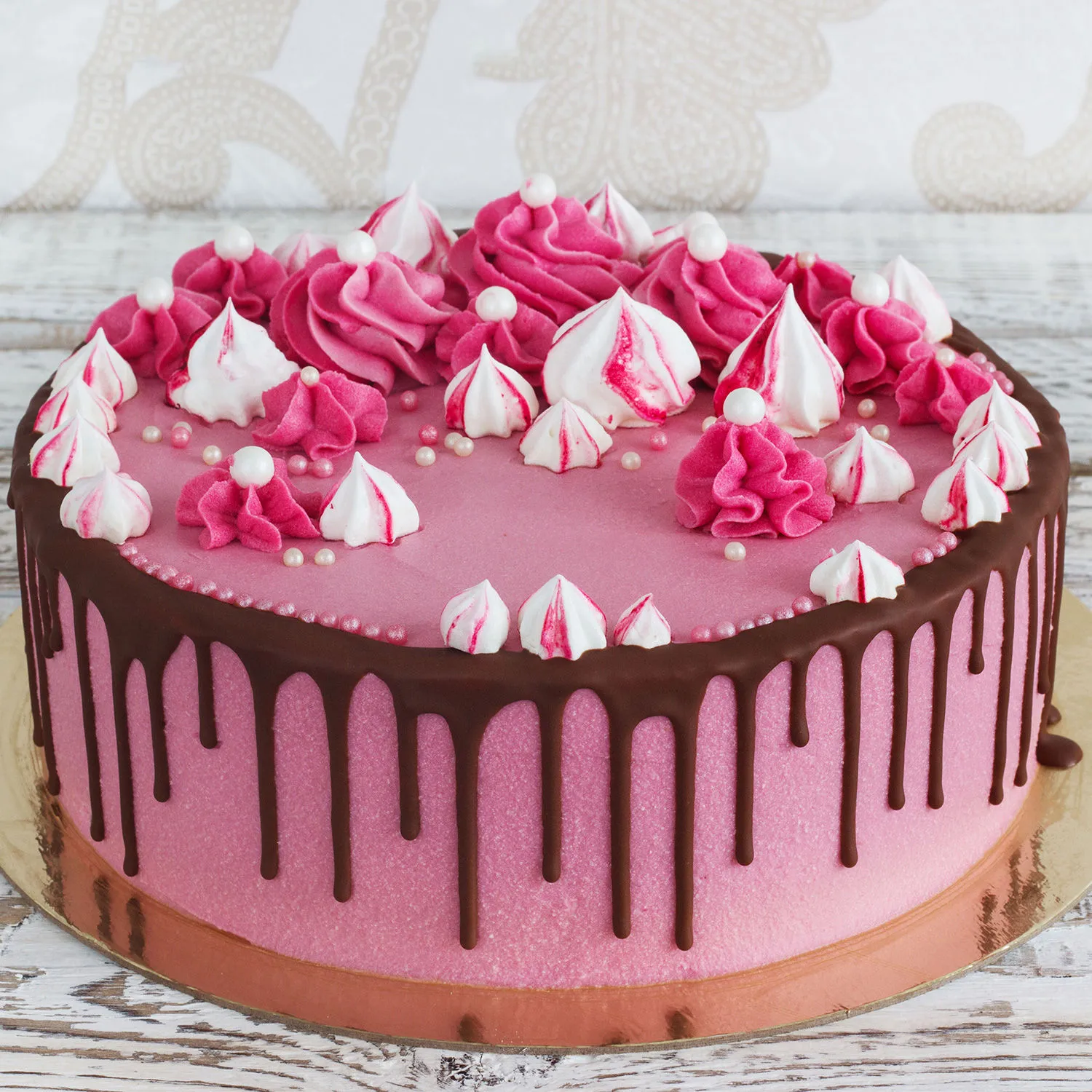 Pink strawberry cake garnished with Chocolate truffle