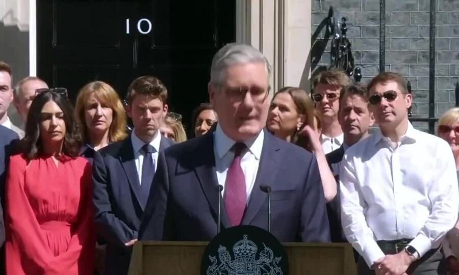 Prime minister speaking outside a government building to reporters, realistic photojournalism style, no text or logos