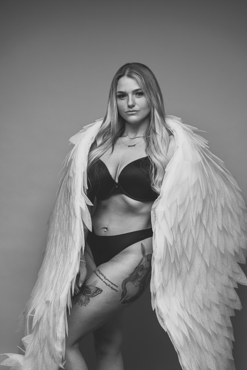 Wide glamour portrait with bold studio lighting