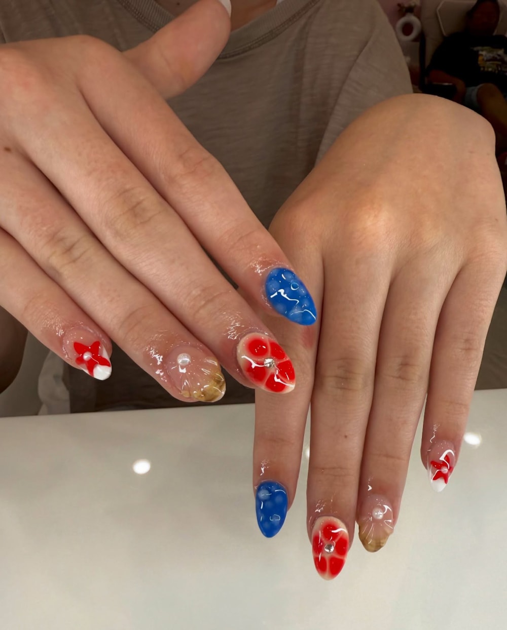 red and blue nail art and 3D nails, almond shape — nail salon in Calhoun, GA — Sonny & Tee
