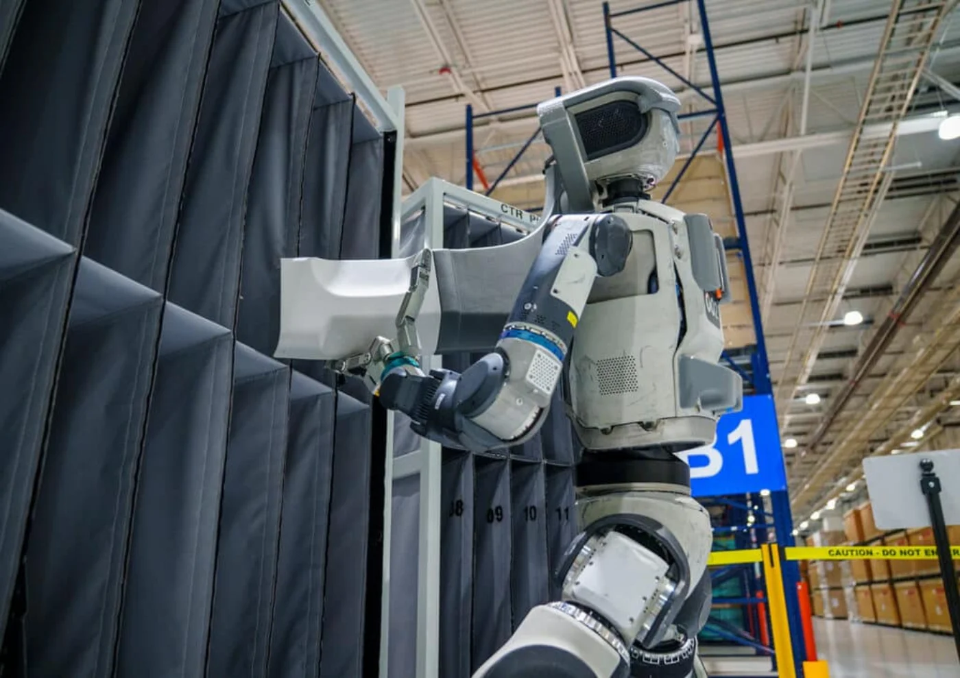 Boston Dynamics Atlas electric humanoid robot demonstrating how humanoid robots work at a customer facility
