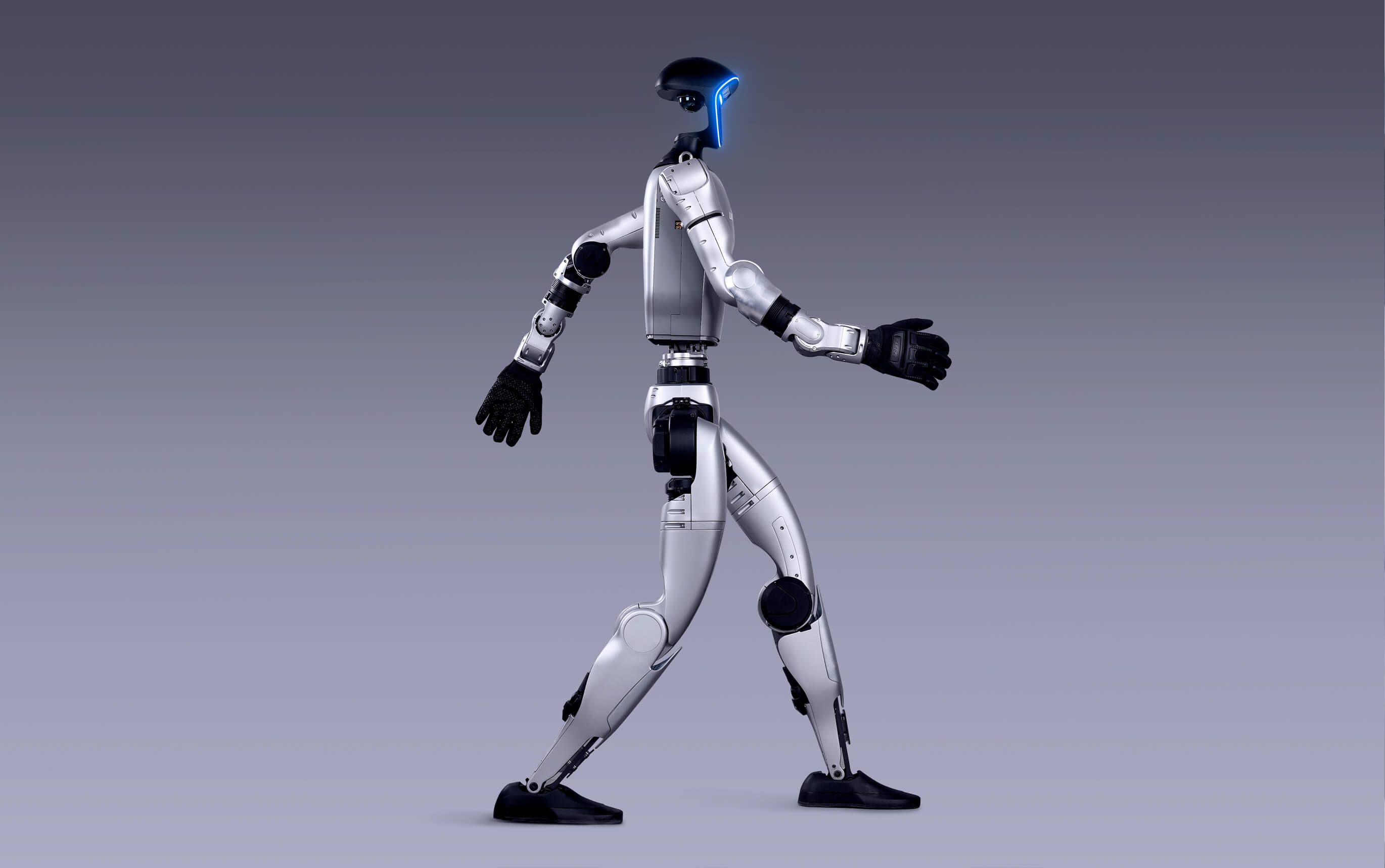 Unitree G1 walking side view, showing the 2 m/s bipedal gait in a controlled environment. Image: Unitree Robotics