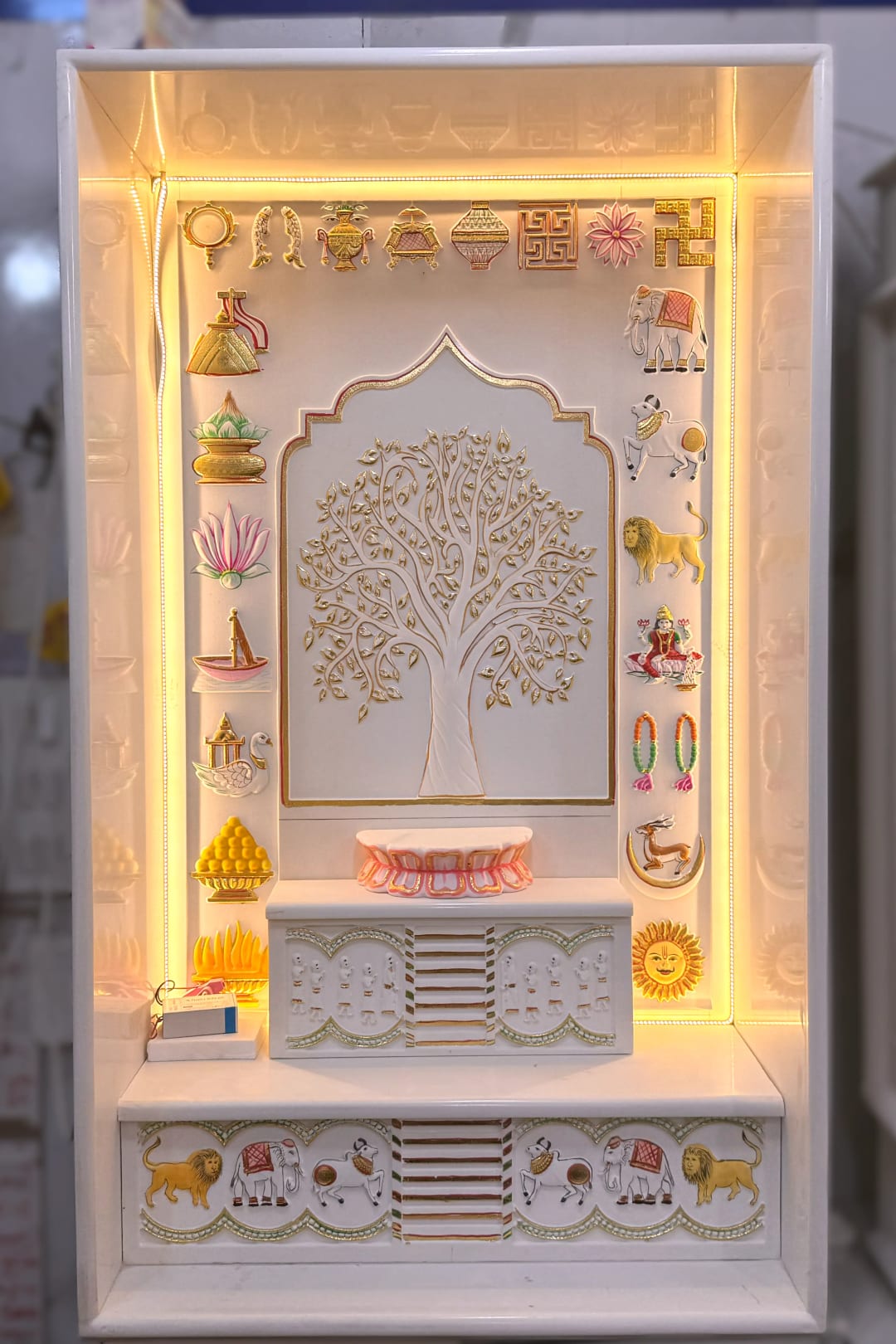 Jain marble panel carved with the symbolic patterns used in derasar work
