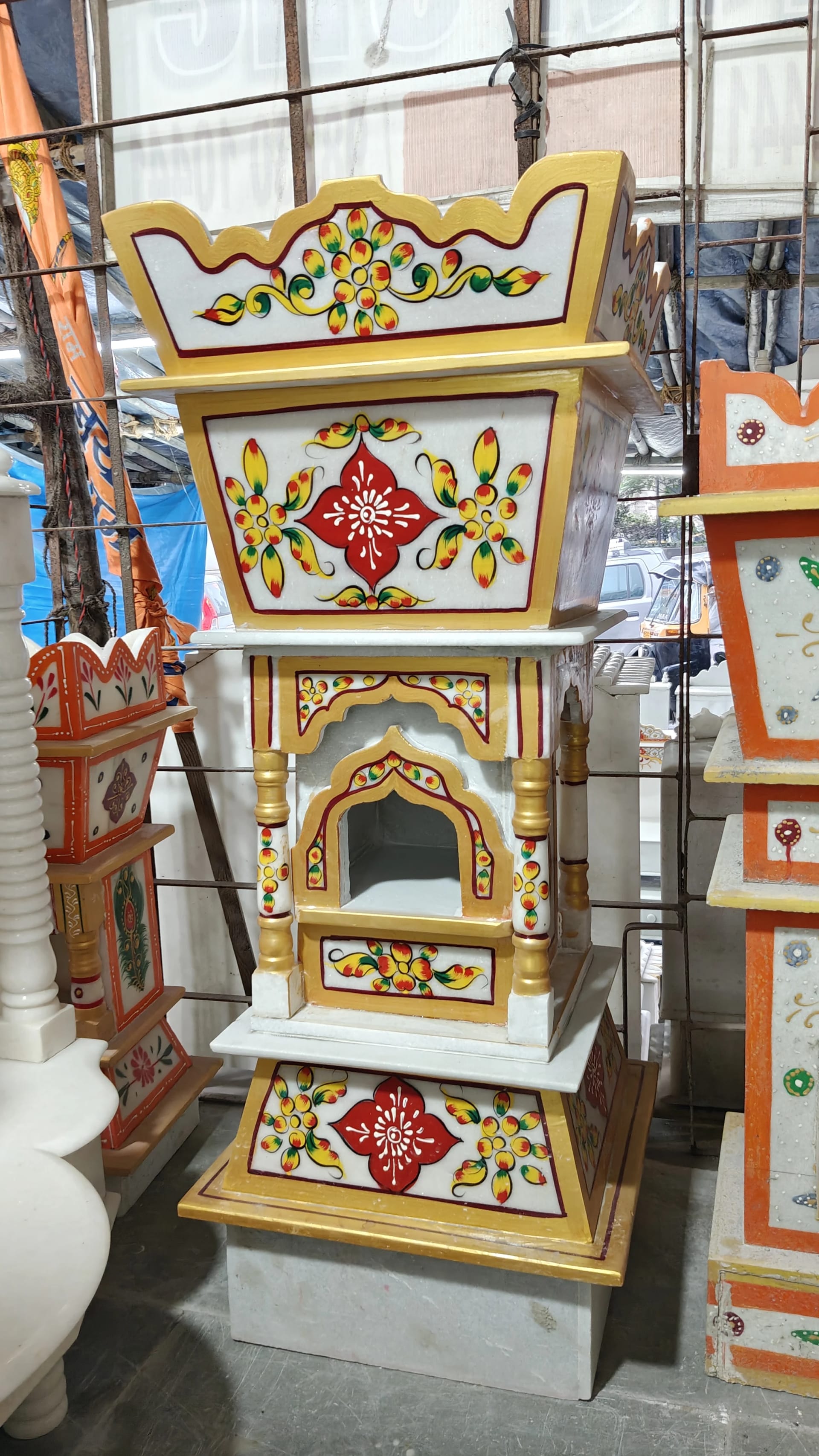 Marble tulsi stand, flowers carved around the base and the rim