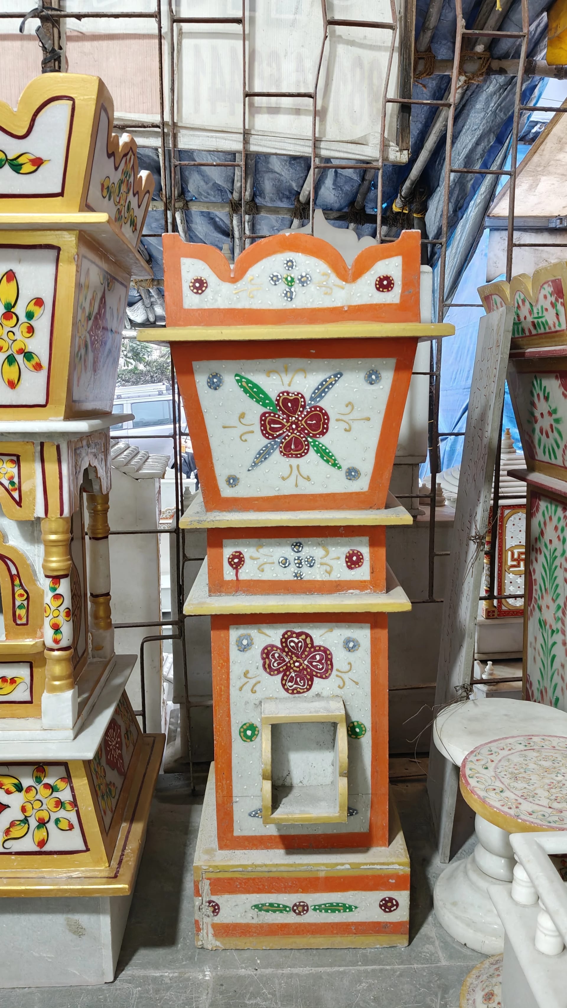 Marble tulsi stand, flowers carved around the base and the rim