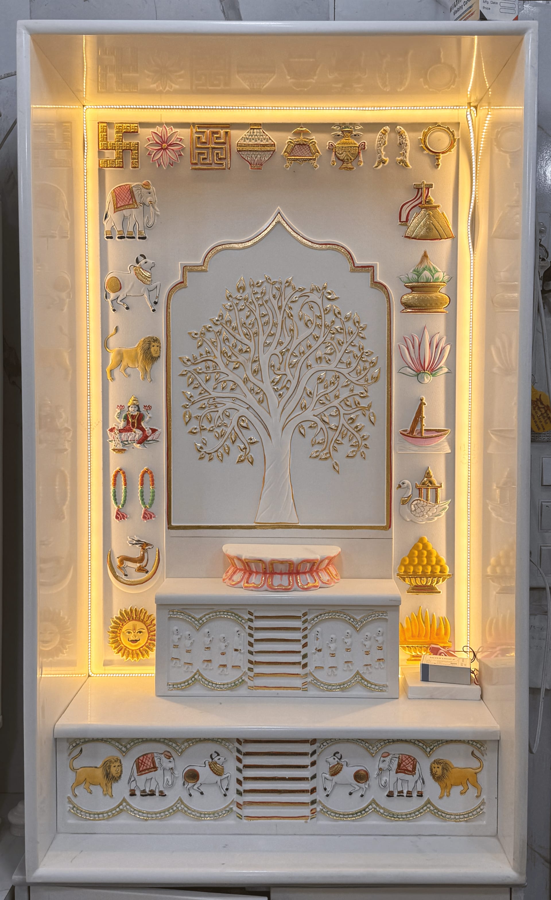 Jain shrine in polished white marble, plain surfaces framing a carved doorway