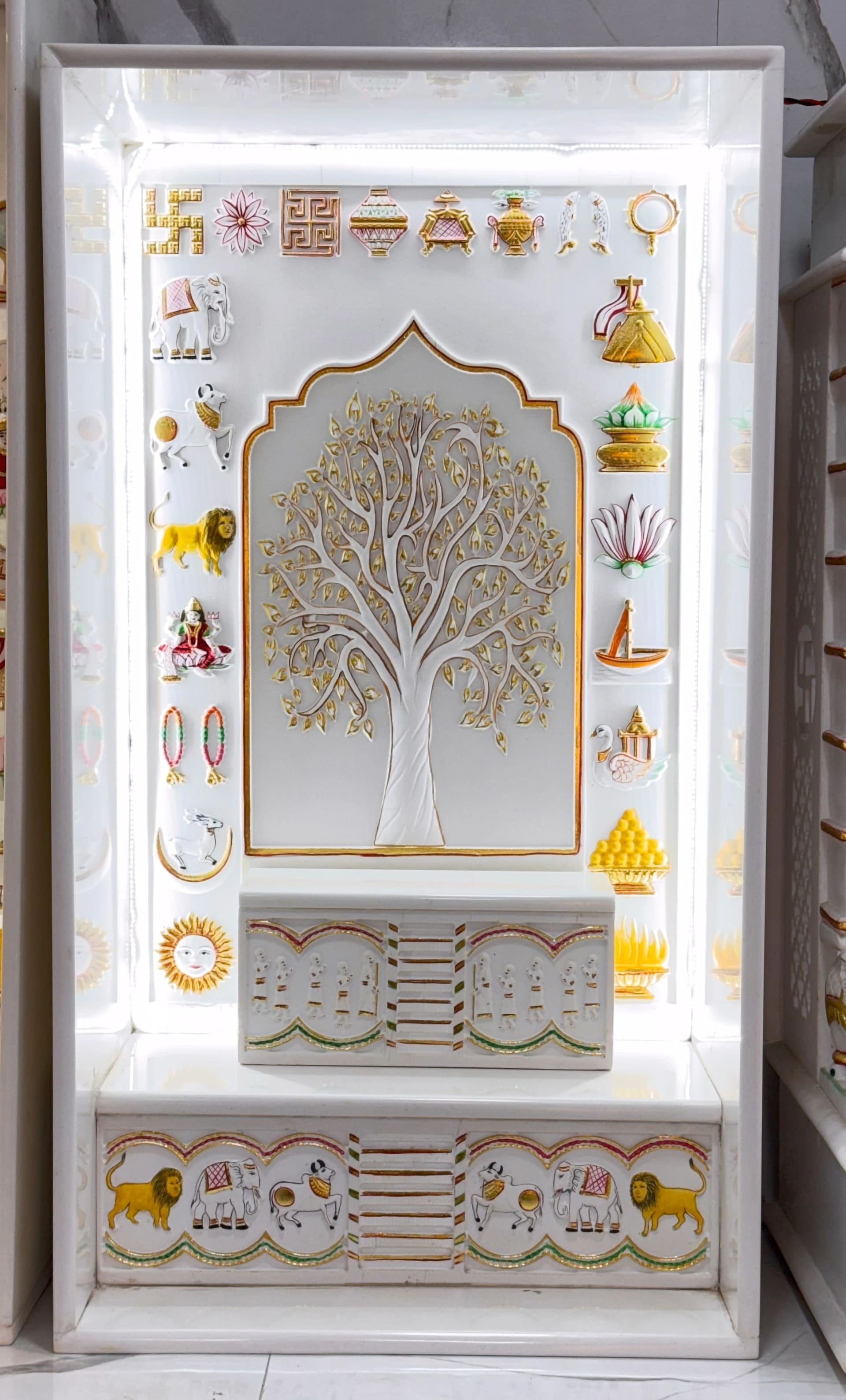 Mandir with the 14 Swapna carved in relief in a row across the upper panel
