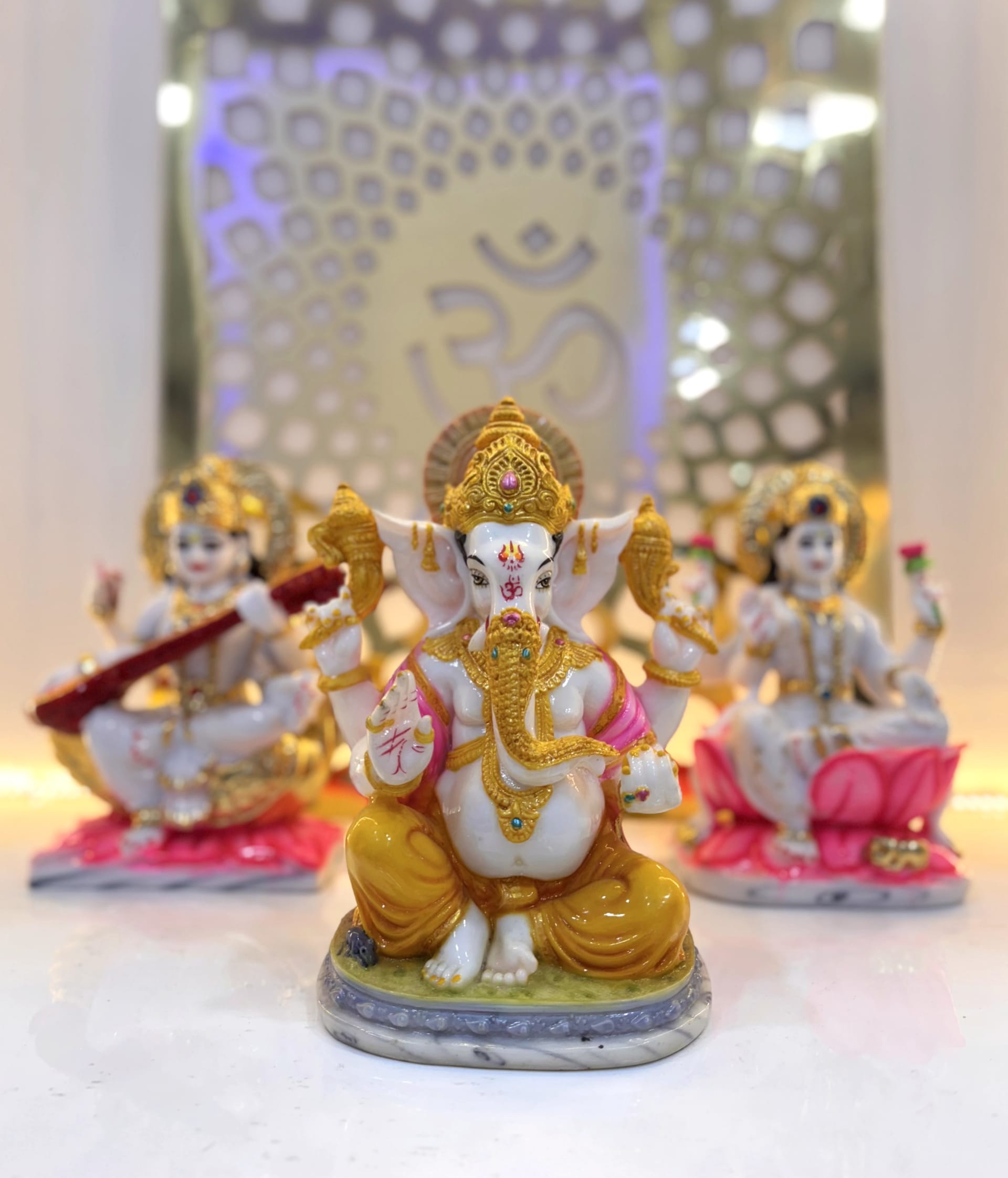 Seated Jain Tirthankar murti in white marble, hands resting in the lap