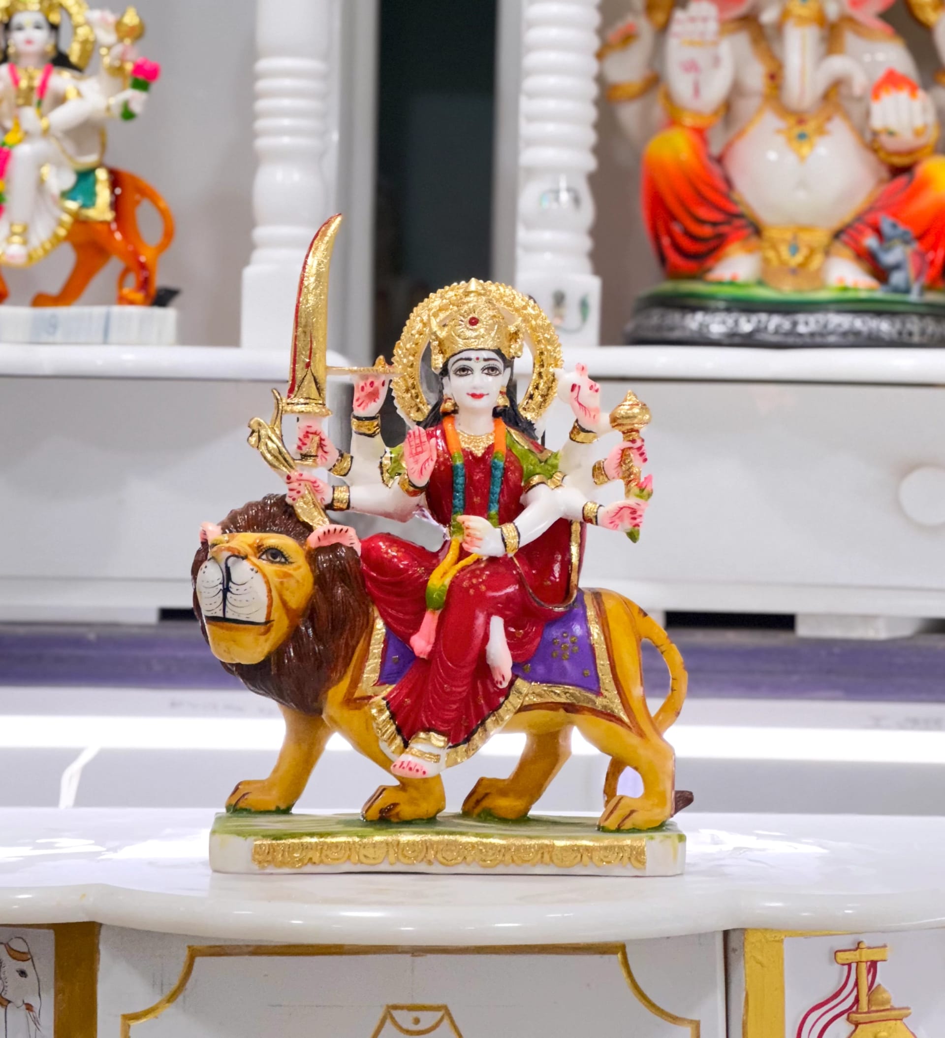 Ambe Mata murti in marble, seated and crowned, fine carving across the robes