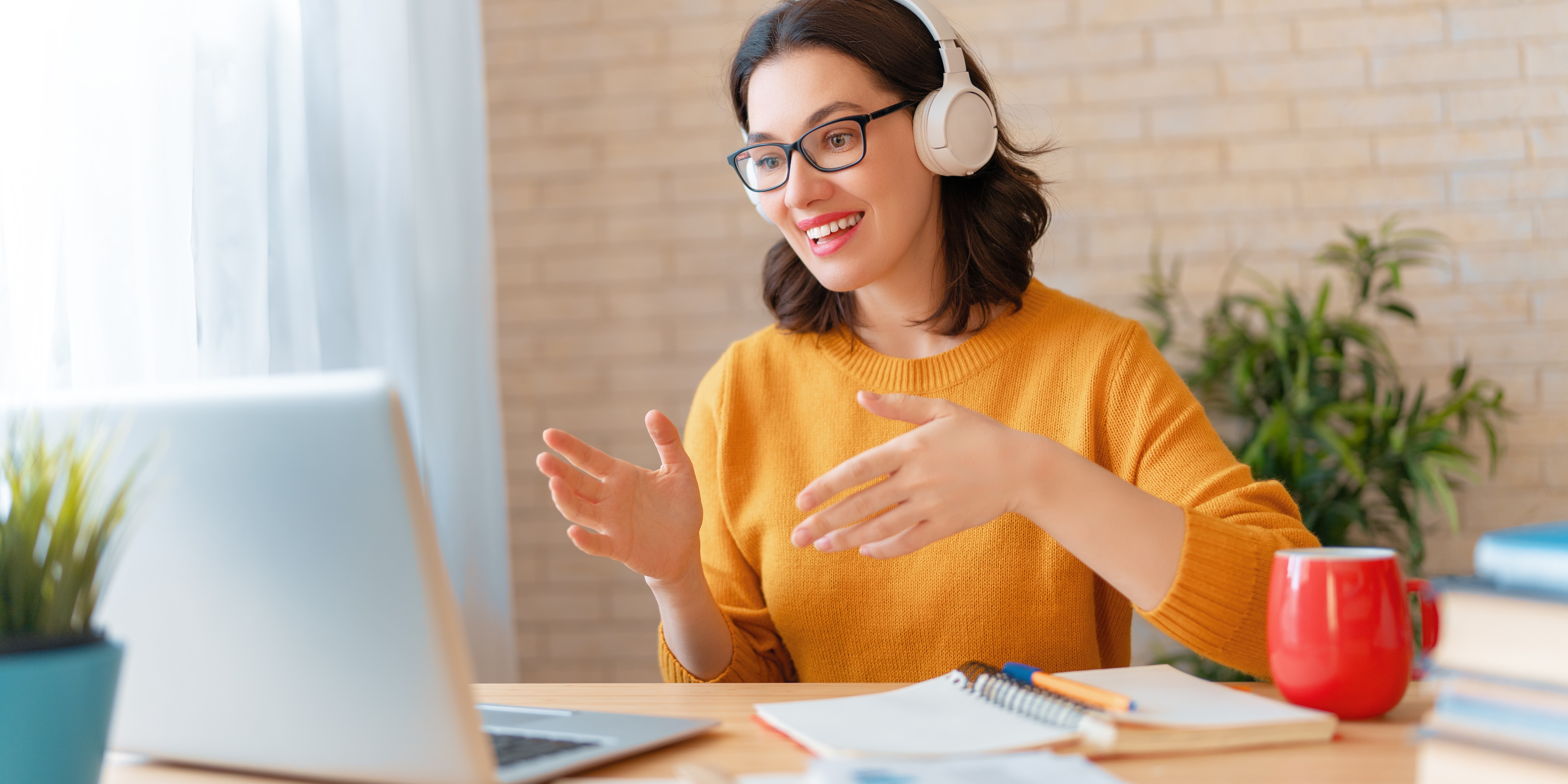Candidate practicing free AI mock interview on laptop using headset during virtual interview simulation