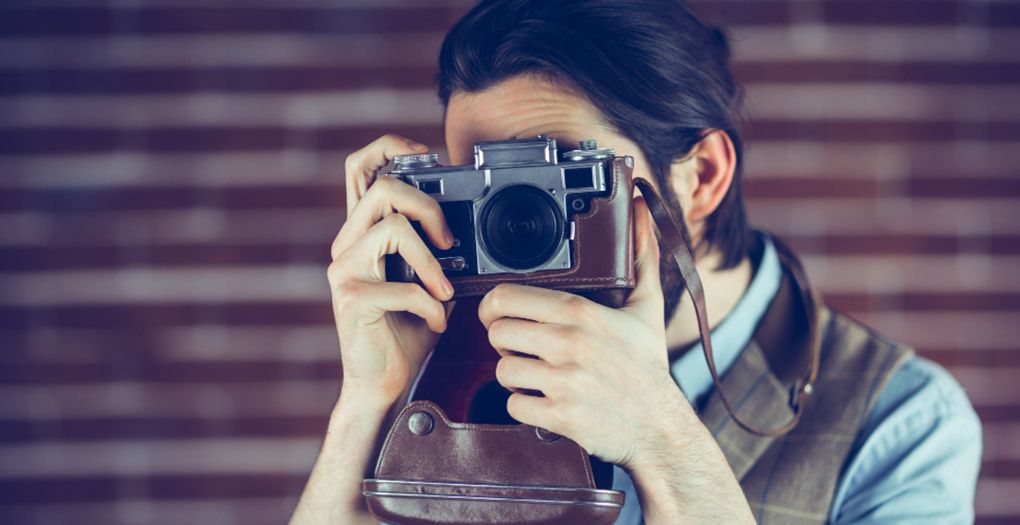 A man capturing a moment with a classic camera.