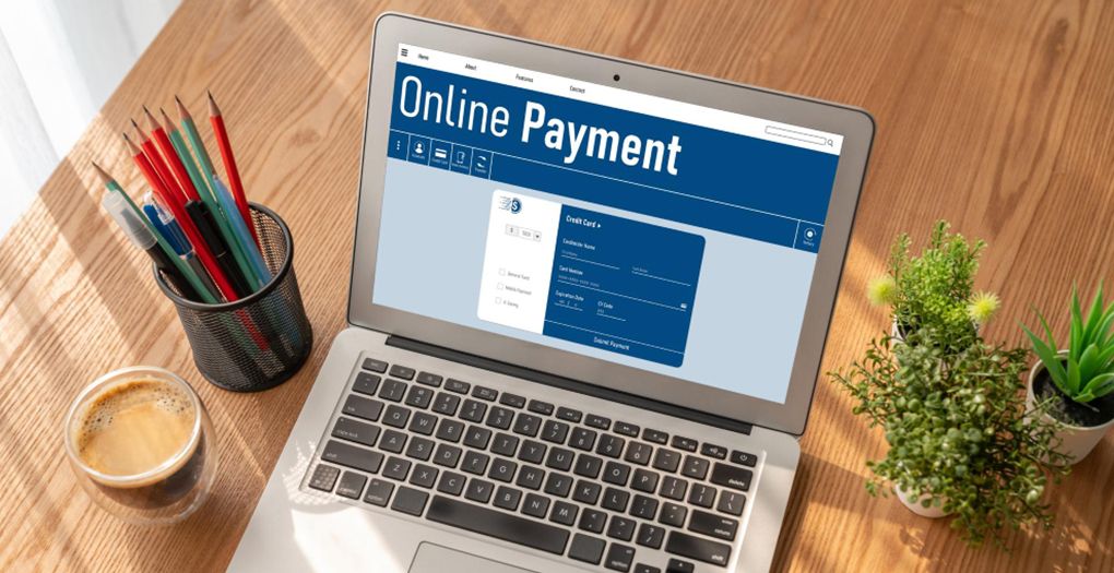 Online payment process on a laptop screen, featuring a person entering credit card details for a secure transaction.