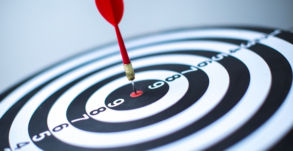 A dart precisely hitting the bullseye on a dartboard, demonstrating accuracy and skill in the game of darts.