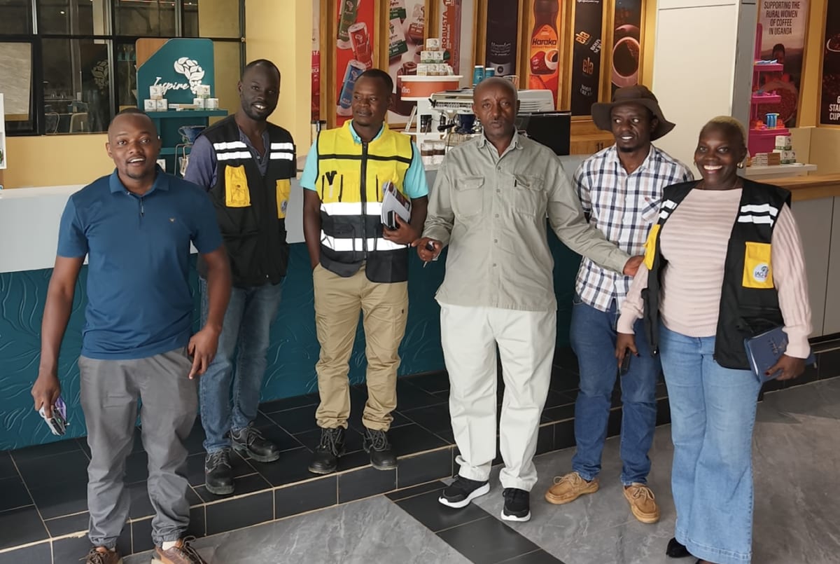 Inspire Africa Coffee Park team in the showroom with roasted Ugandan coffee