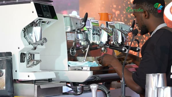 Barista crafting espresso from single-origin Ugandan Robusta at Inspire Africa Coffee Park