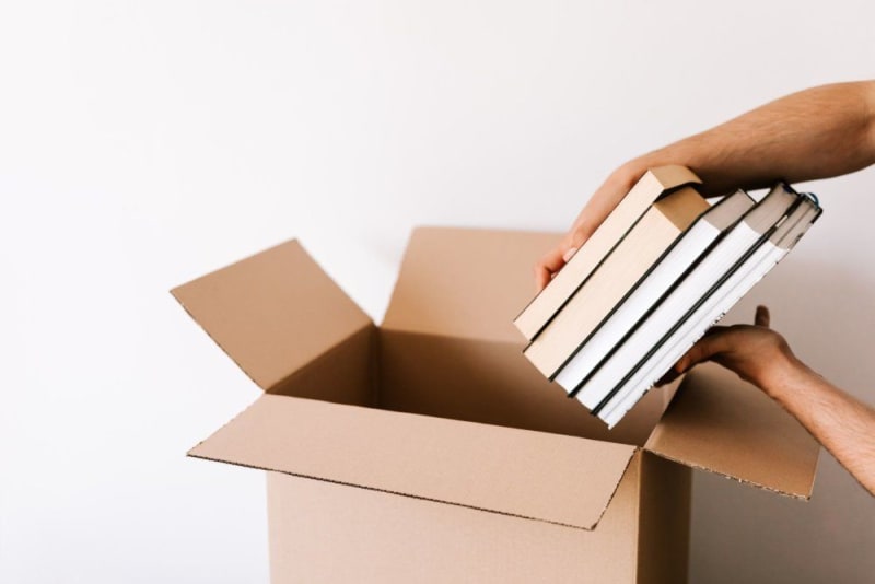 Packing books into the box Packing books into the box