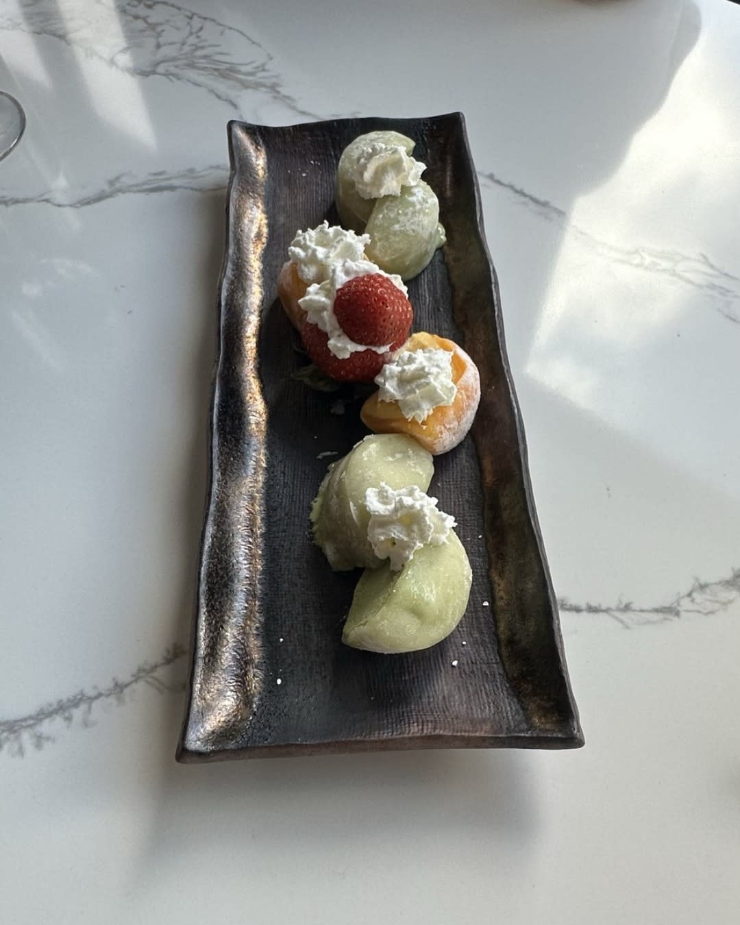 Dessert plate at Izumi Sushi in downtown Castle Rock — strawberry, mango, matcha ice cream from the chef