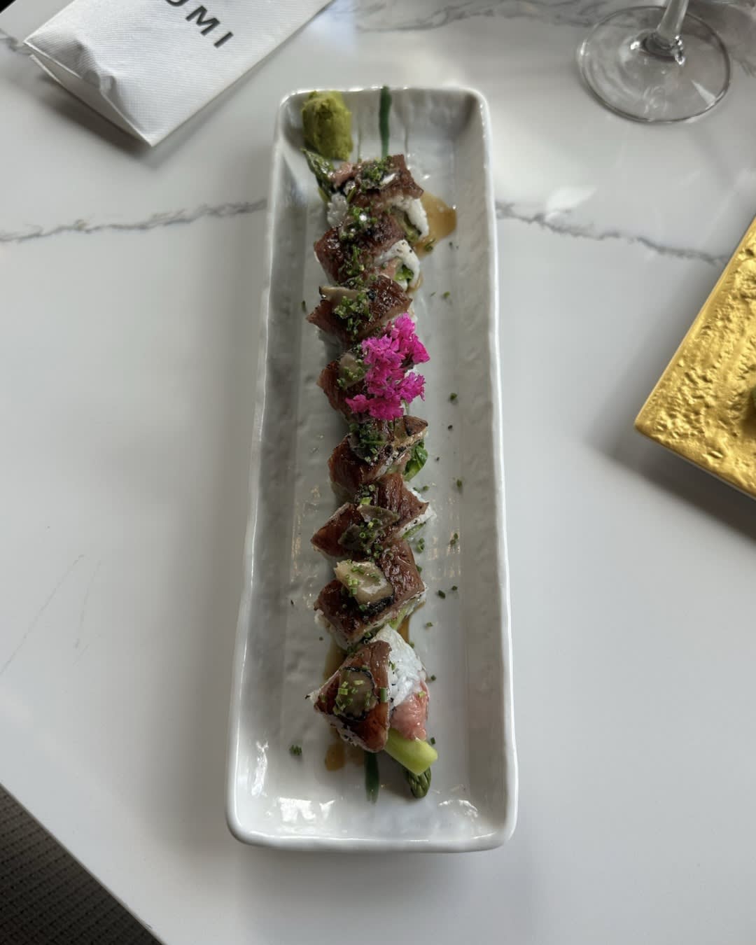 Kobe Beef Truffle Roll on long white plate at Izumi Sushi in downtown Castle Rock