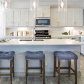 The kitchen island offers additional seating and c