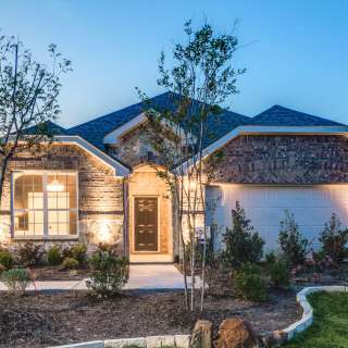 The Mckinney, a one-story home with 2-car garage, shown with Home Exterior C