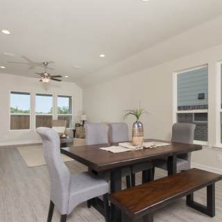 The intimate dining space offers access to both the kitchen and gathering room