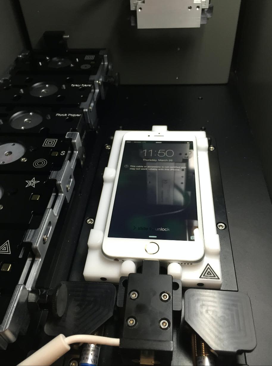 Professional testing of iPhone OLED screens in a repair lab setting