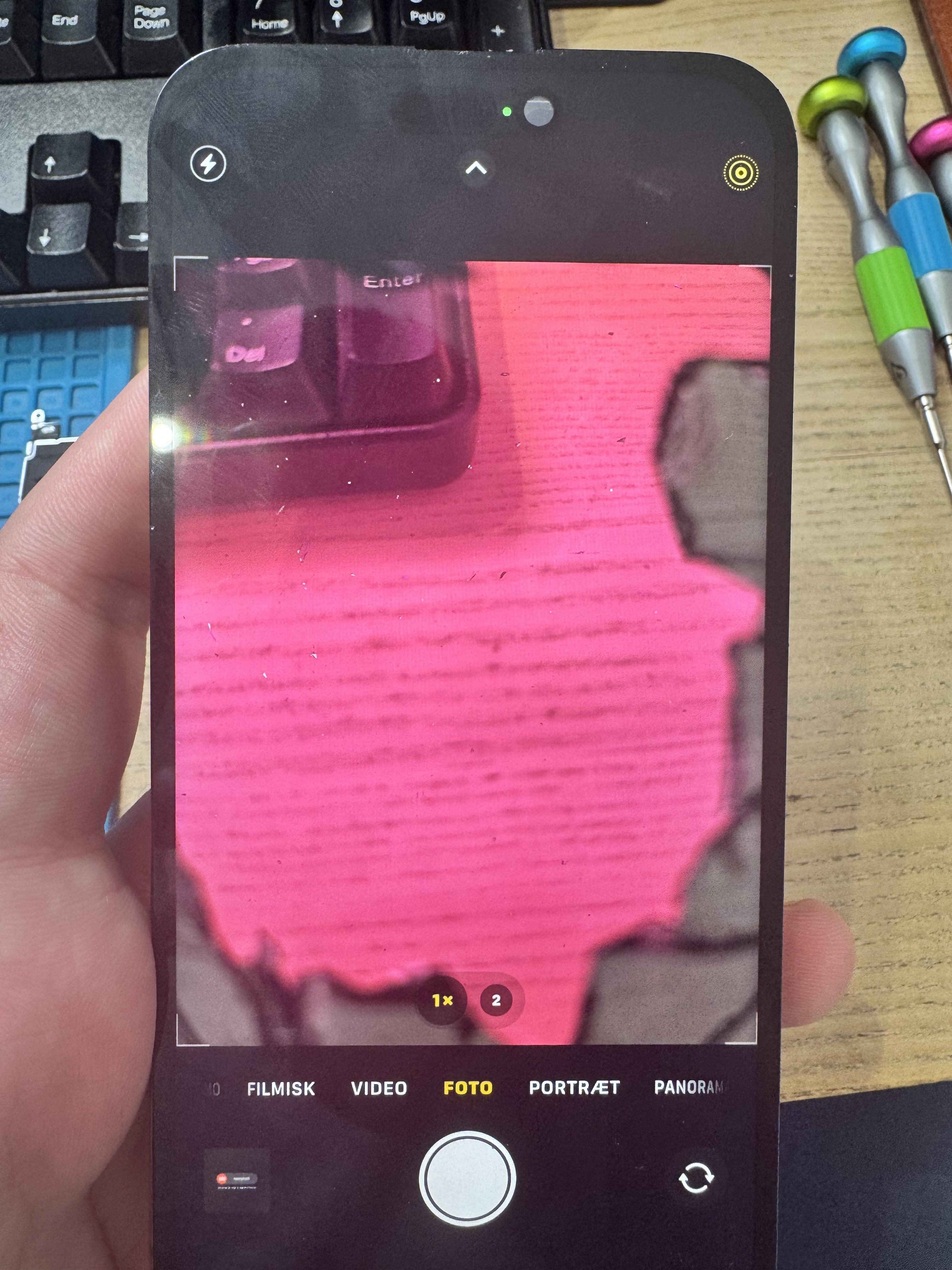 Original Reddit photo submitted by u/Different_Local_1598 — a customer-returned iPhone with the rear camera lens glass visibly shattered alongside the cracked screen the shop was blamed for