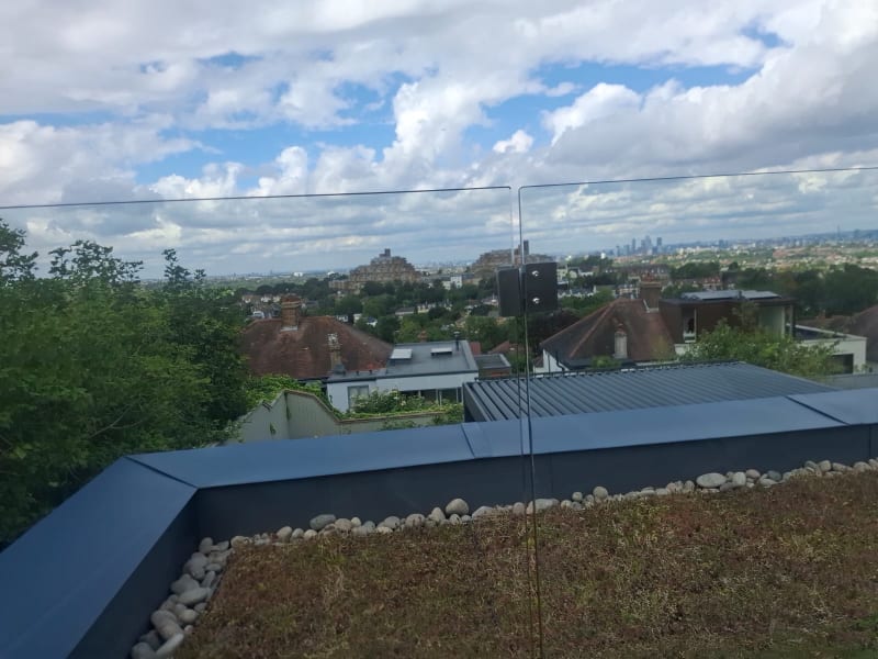 Green roof terrace with lounge seating and city views