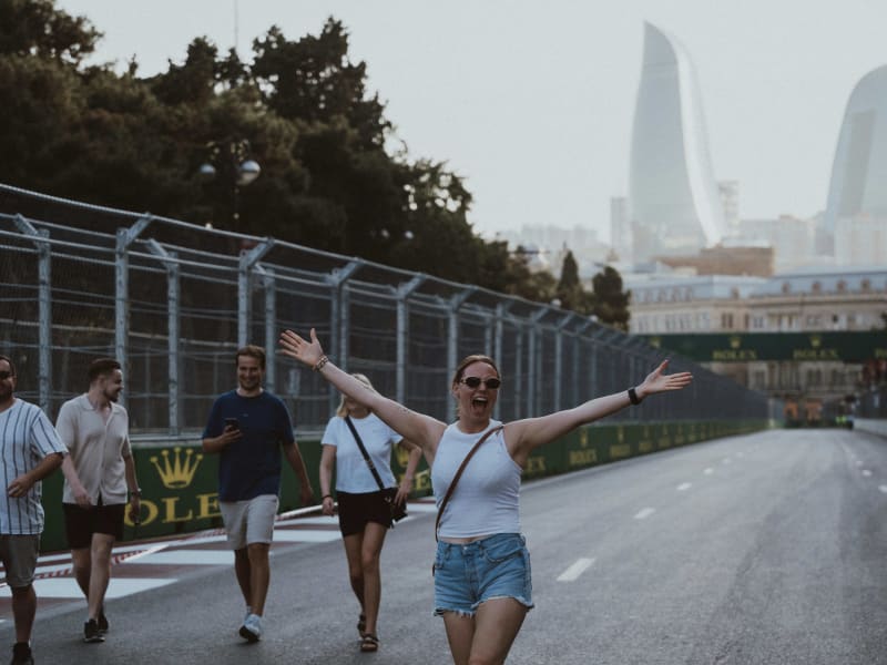 Visitors beside the Baku race circuit with the Flame Towers in the distance