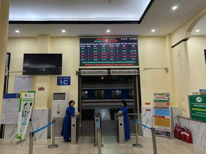 Inside Hanoi Railway Station and billboard featuring train schedule