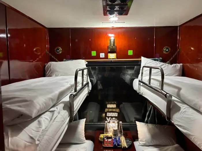Two bunk beds in a train cabin