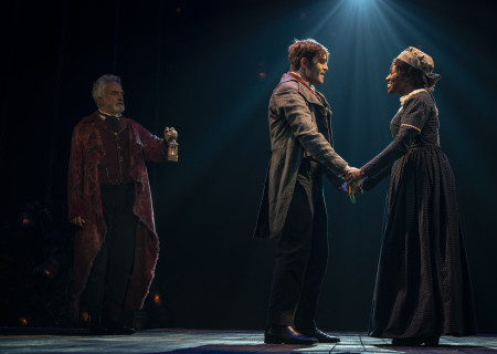 L-R: Bradley Whitford, Harry Thornton, and Glory Yepassis-Zembrou in  'A Christmas Carol.' Photo by Joan Marcus.