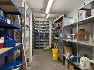 Shelving System with Spare Parts, Hydraulic Components, and Operating Supplies